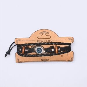 NWT. Black and Brown Braided Bracelet with Eye Charm.